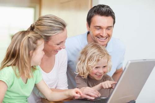 Family using notebook in the kitchen together