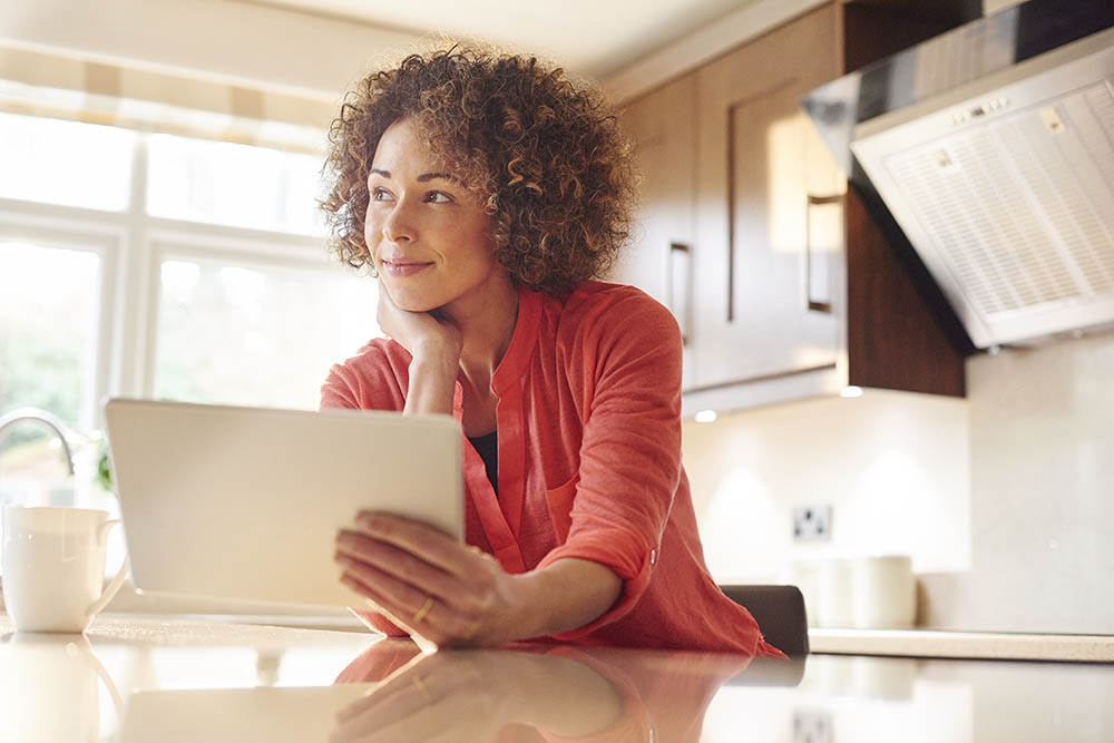 woman in kitchen with tablet